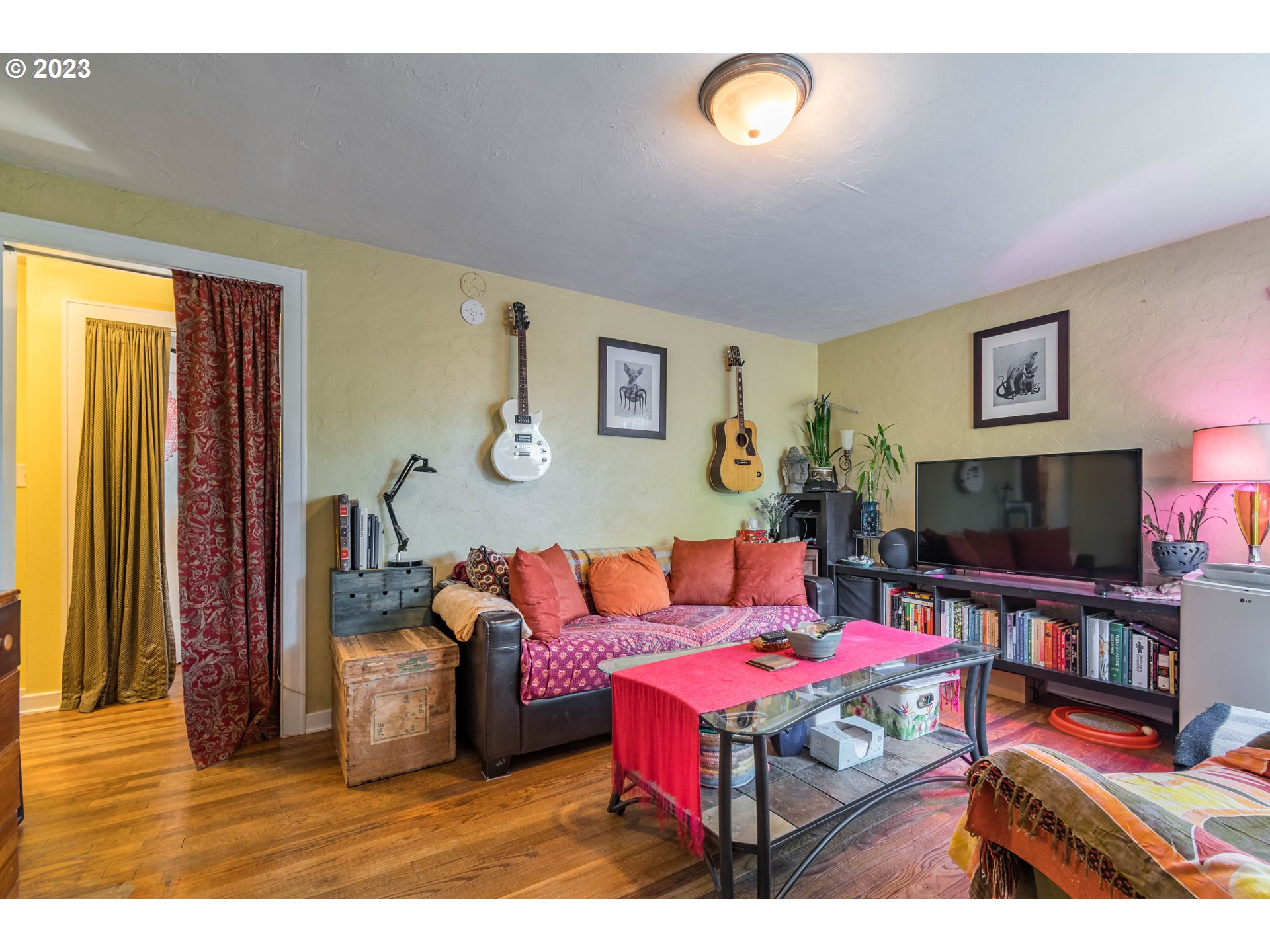1275 West 5th Avenue Eugene, OR 97402 - Photo 3 of 31 a living room with furniture and a flat screen tv