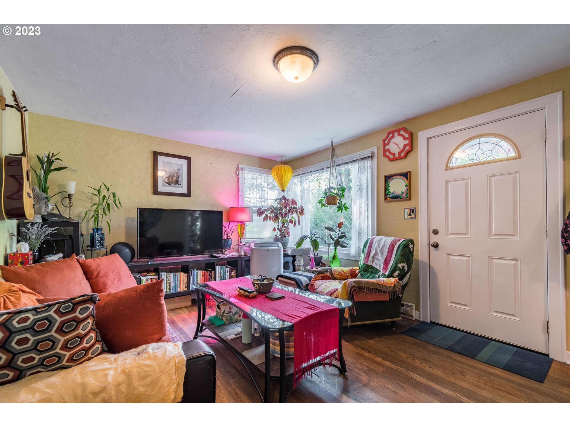 1275 West 5th Avenue Eugene, OR 97402 - Photo 4 of 31 a outdoor living space with furniture and a flat screen tv