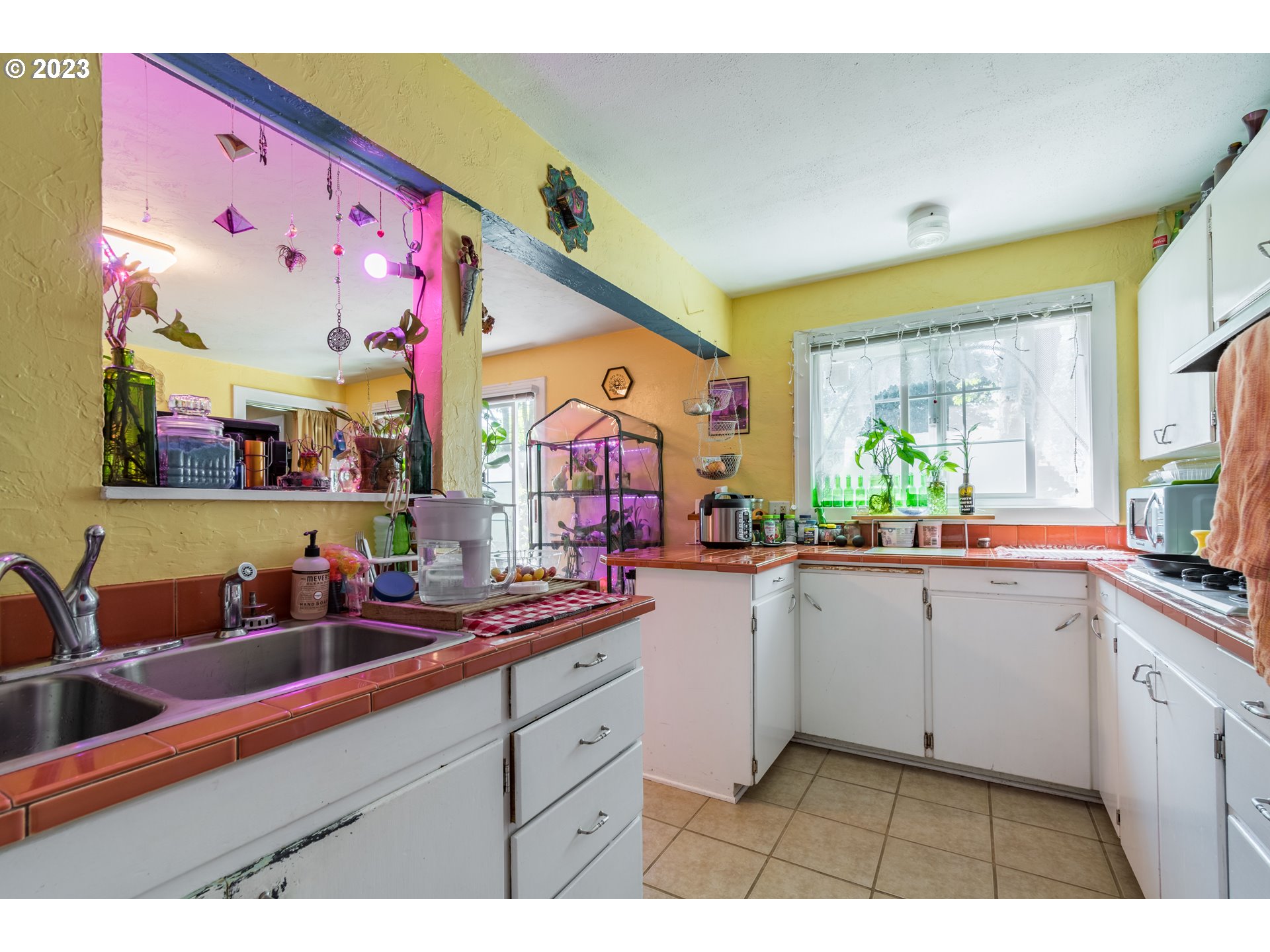 1275 West 5th Avenue Eugene, OR 97402 - Photo 10 of 31 a kitchen with granite countertop a sink cabinets and window