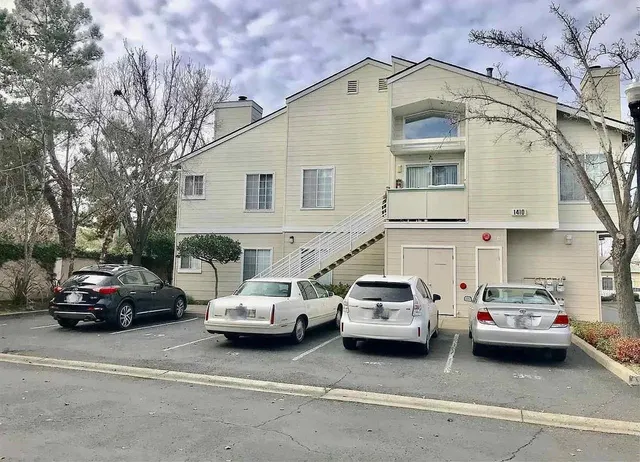 a view of a cars park in front of a house