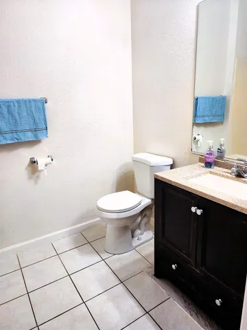 a spacious bathroom with a sink toilet and mirror