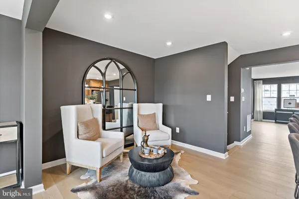 a living room with furniture a window and a potted plant