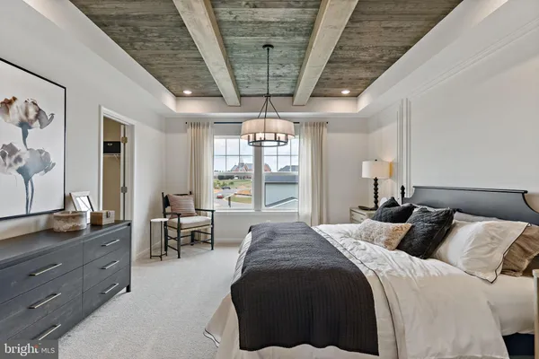 a spacious bedroom with a large bed and a window