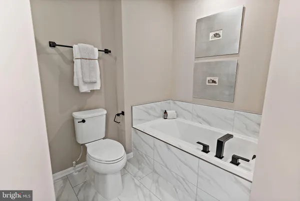 a white toilet sitting next to a bathroom sink