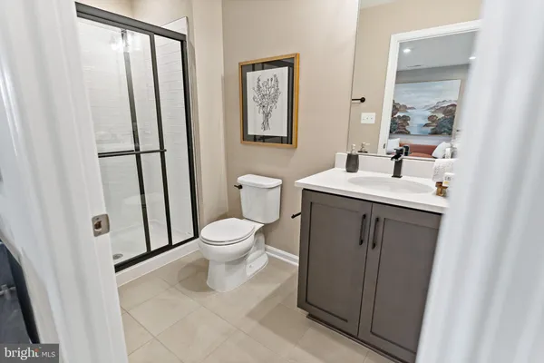 a white toilet sitting next to a bathroom sink