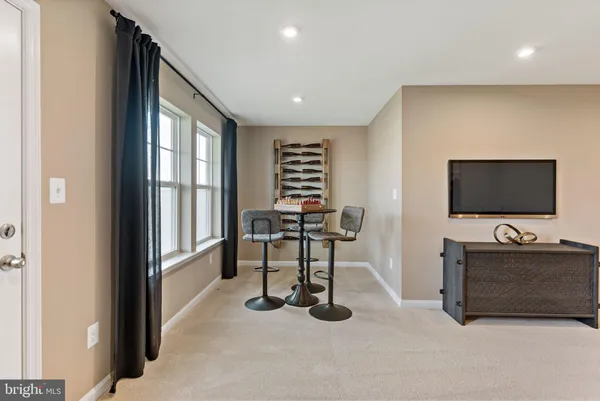 a view of a livingroom with furniture and a flat screen tv