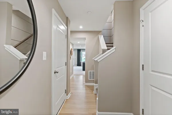 a view of hallway with stairs and wooden floor
