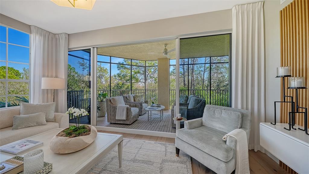 6465 Water Crest Way, Unit 301 Lakewood Ranch, FL 34202 - Photo 11 of 85 a living room with furniture and a large window