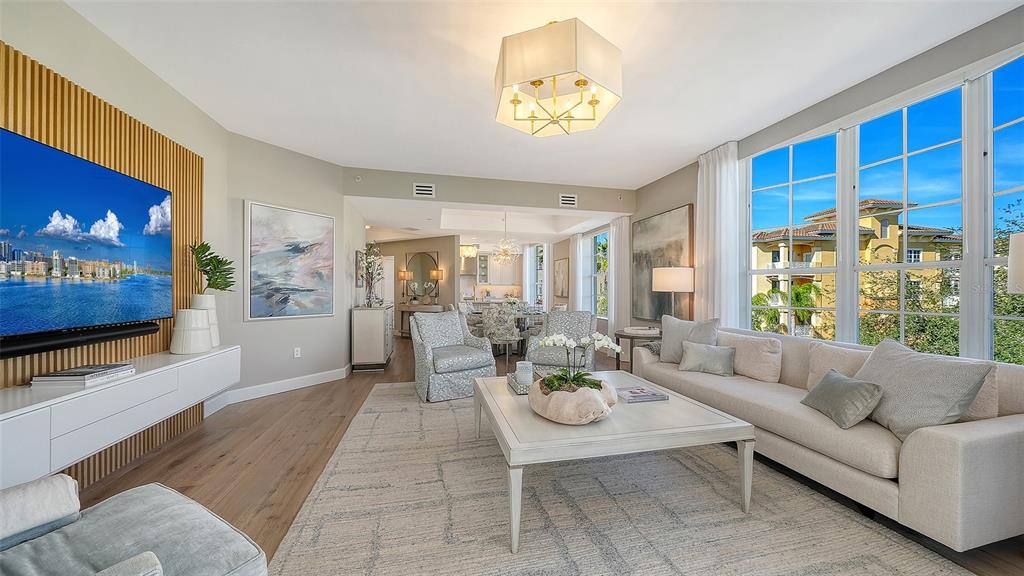 6465 Water Crest Way, Unit 301 Lakewood Ranch, FL 34202 - Photo 12 of 85 a living room with furniture and a flat screen tv