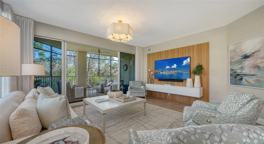 6465 Water Crest Way, Unit 301 Lakewood Ranch, FL 34202 - Photo 13 of 85 a living room with furniture and a flat screen tv