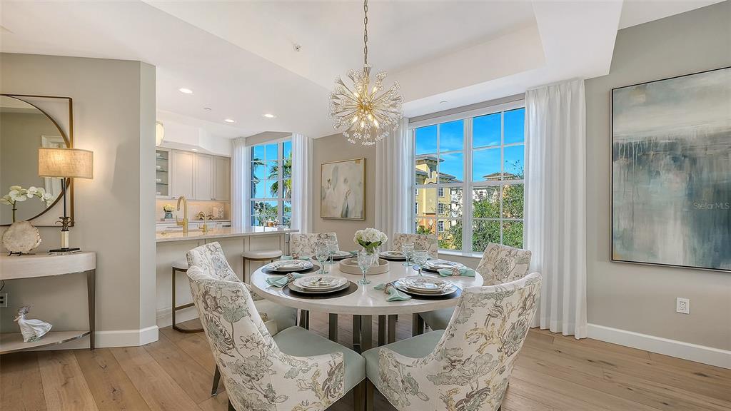 6465 Water Crest Way, Unit 301 Lakewood Ranch, FL 34202 - Photo 14 of 85 a view of a dining room with furniture window and wooden floor
