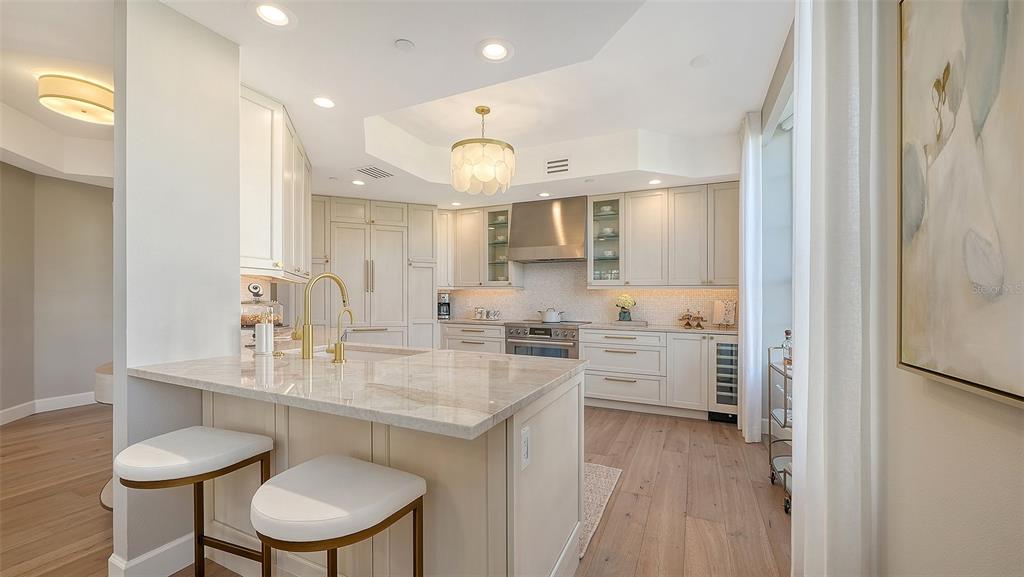 6465 Water Crest Way, Unit 301 Lakewood Ranch, FL 34202 - Photo 16 of 85 a kitchen with a sink cabinets and wooden floor