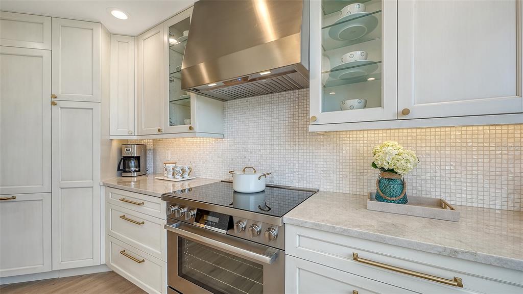 6465 Water Crest Way, Unit 301 Lakewood Ranch, FL 34202 - Photo 18 of 85 a kitchen with stainless steel appliances white cabinets and a window