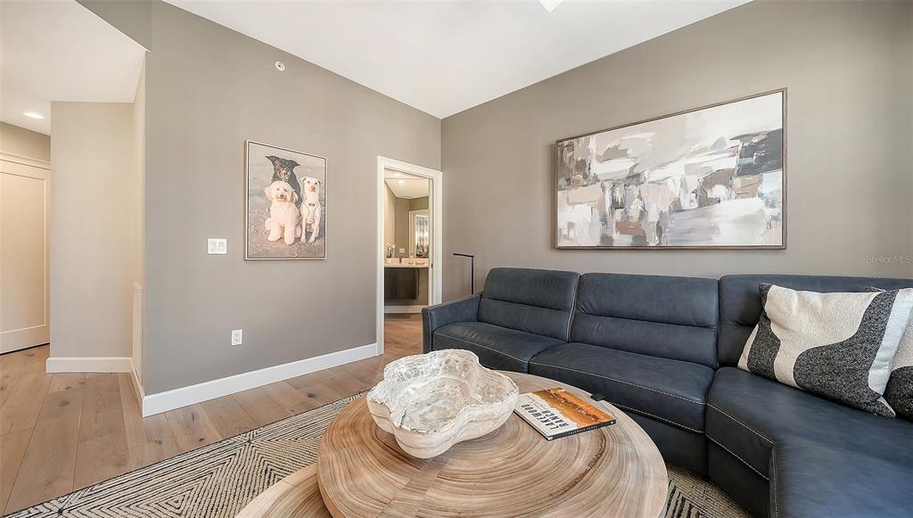 6465 Water Crest Way, Unit 301 Lakewood Ranch, FL 34202 - Photo 25 of 85 a living room with furniture and a wooden floor