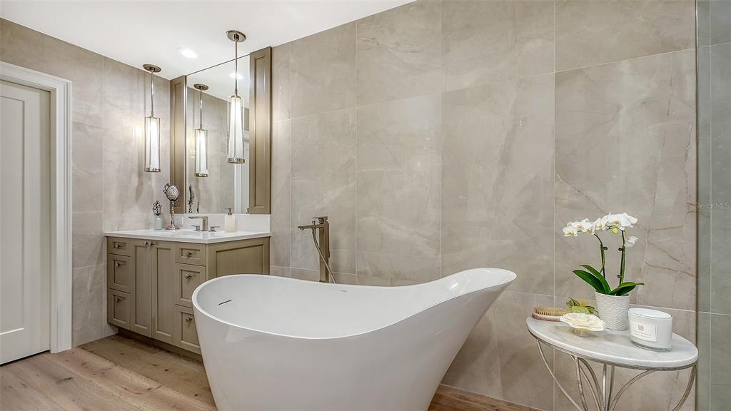 6465 Water Crest Way, Unit 301 Lakewood Ranch, FL 34202 - Photo 34 of 85 a white bath tub sitting in a bathroom and sink