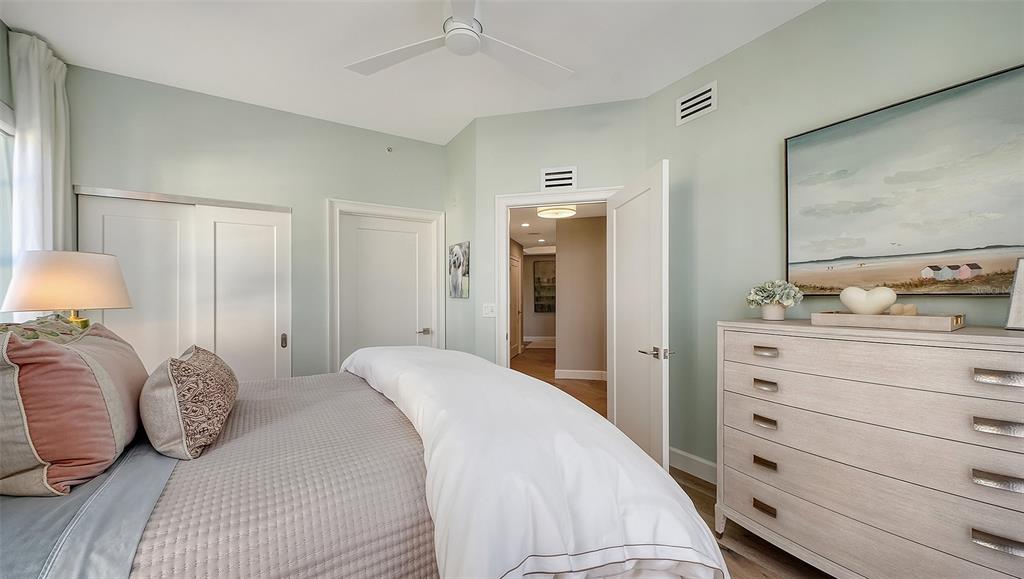6465 Water Crest Way, Unit 301 Lakewood Ranch, FL 34202 - Photo 36 of 85 a bedroom with a bed and a dresser