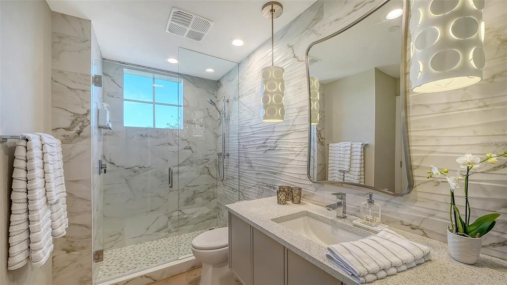 6465 Water Crest Way, Unit 301 Lakewood Ranch, FL 34202 - Photo 37 of 85 a bathroom with a sink a toilet and shower