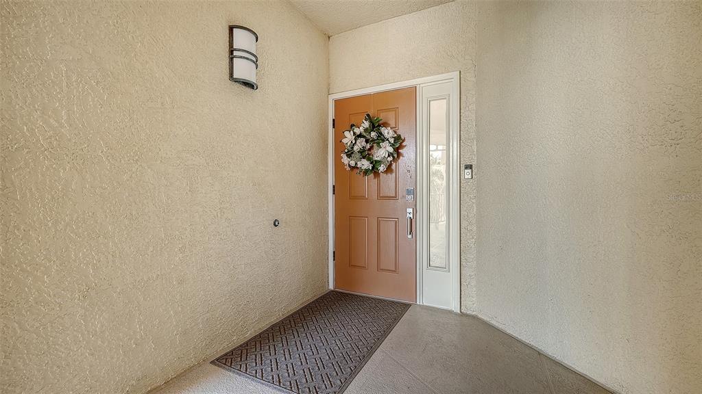 6465 Water Crest Way, Unit 301 Lakewood Ranch, FL 34202 - Photo 4 of 85 a view of a hallway with wooden floor and closet