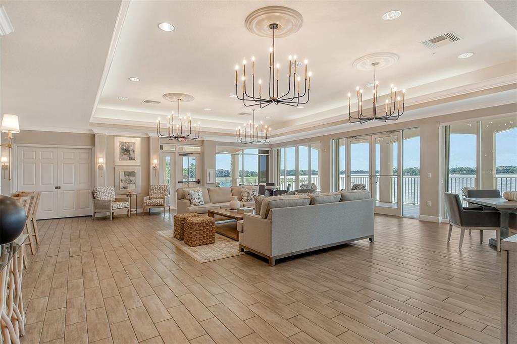 6465 Water Crest Way, Unit 301 Lakewood Ranch, FL 34202 - Photo 48 of 85 a living room with furniture and a chandelier
