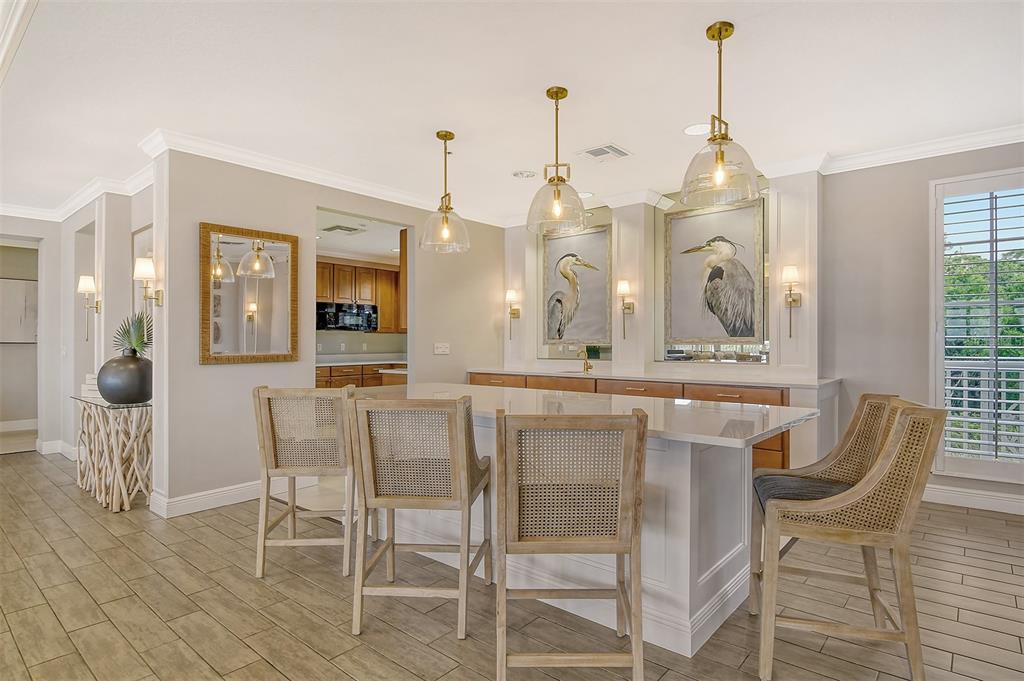 6465 Water Crest Way, Unit 301 Lakewood Ranch, FL 34202 - Photo 53 of 85 a view of dining room and livingroom with furniture wooden floor a chandelier