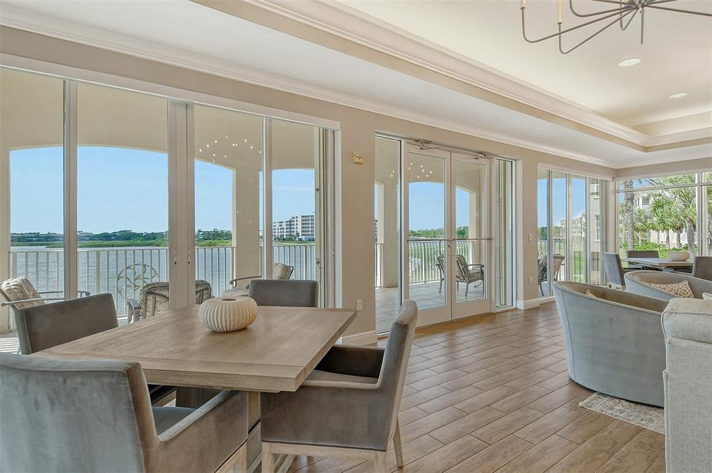 6465 Water Crest Way, Unit 301 Lakewood Ranch, FL 34202 - Photo 54 of 85 a view of a dining room with furniture window and wooden floor