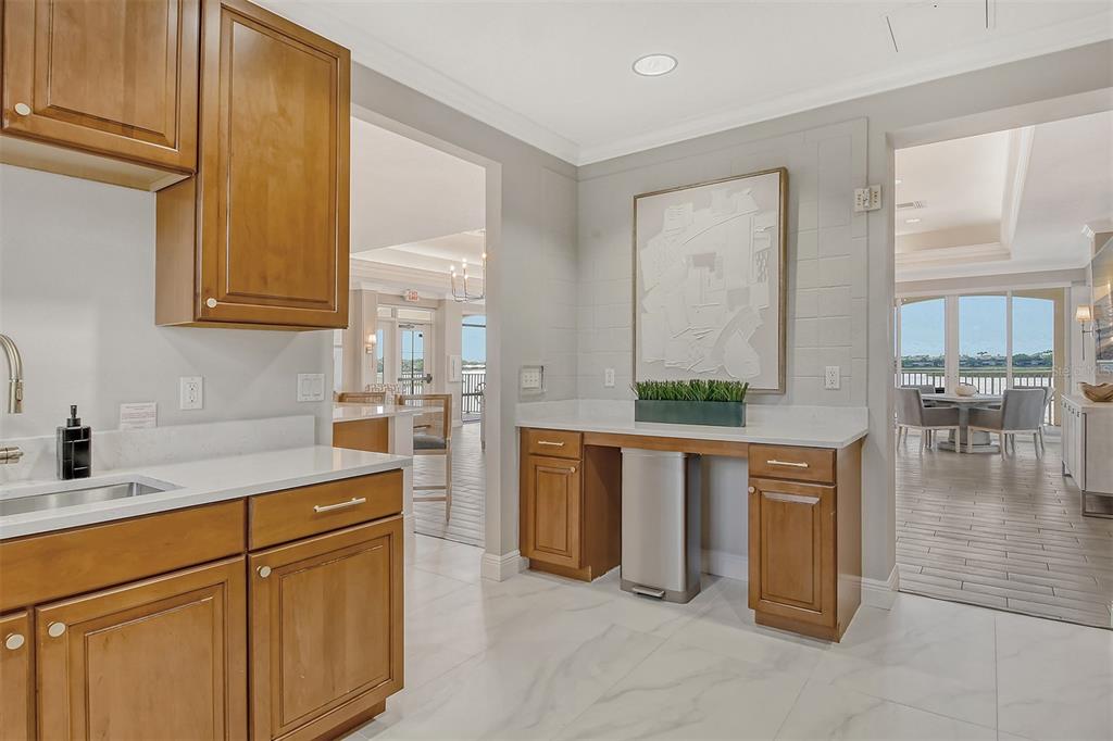 6465 Water Crest Way, Unit 301 Lakewood Ranch, FL 34202 - Photo 59 of 85 a kitchen with stainless steel appliances granite countertop a sink and cabinets