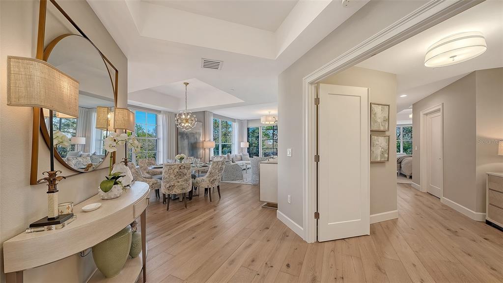 6465 Water Crest Way, Unit 301 Lakewood Ranch, FL 34202 - Photo 7 of 85 a view of a dining room with furniture window and wooden floor
