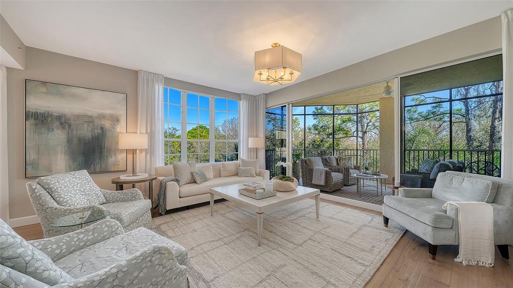 6465 Water Crest Way, Unit 301 Lakewood Ranch, FL 34202 - Photo 10 of 85 a living room with furniture and a large window