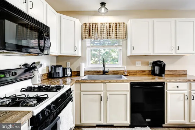 a kitchen with a sink and a window
