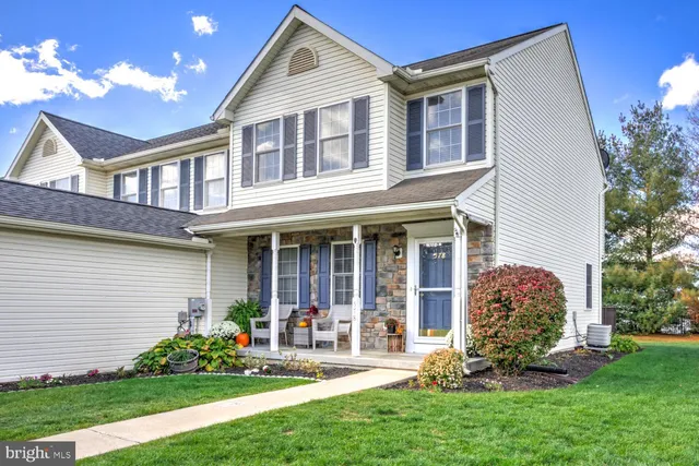 a front view of a house with garden and porch