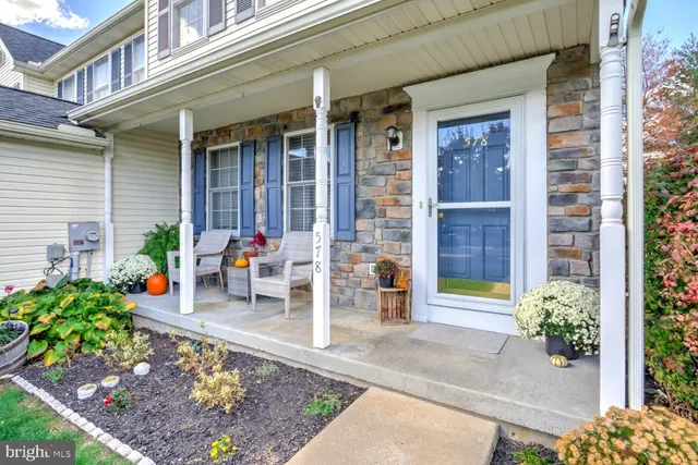 a front view of a house with outdoor seating
