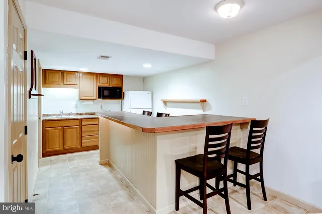 a kitchen with granite countertop cabinets stainless steel appliances and a counter space
