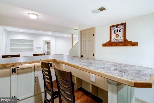 a view of a yard with a table and chairs and potted plants