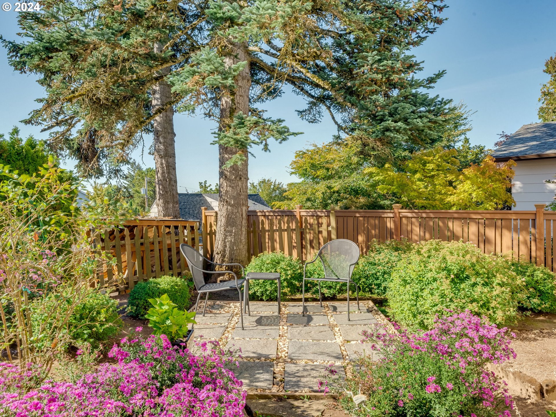4144 Southeast Ogden Street Portland, OR 97202 - Photo 23 of 27 a green field with flowers in front of main door
