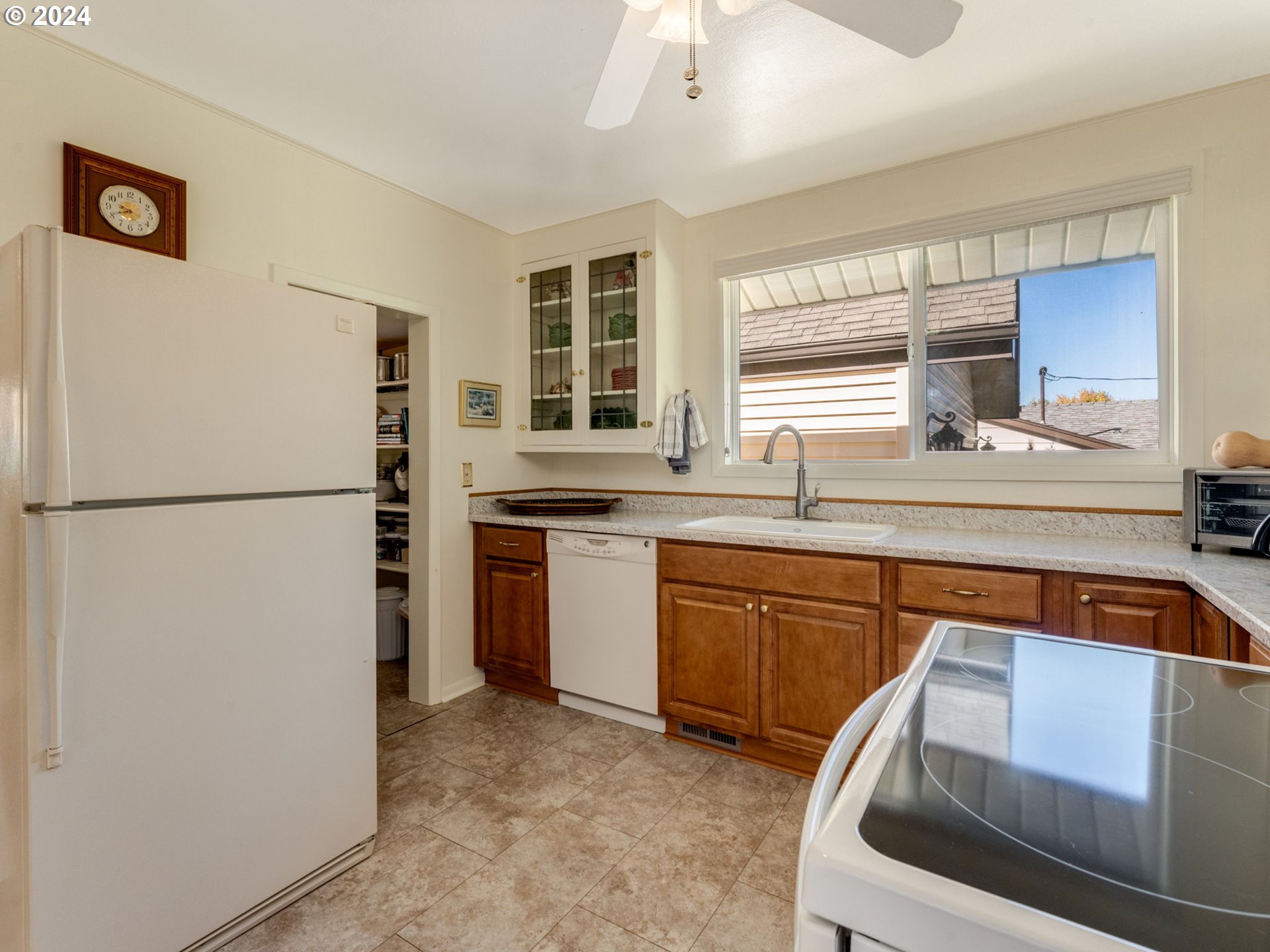 4144 Southeast Ogden Street Portland, OR 97202 - Photo 6 of 27 a kitchen with stainless steel appliances granite countertop a refrigerator a sink a stove a dining table and chairs