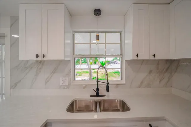 a kitchen with a sink and a window