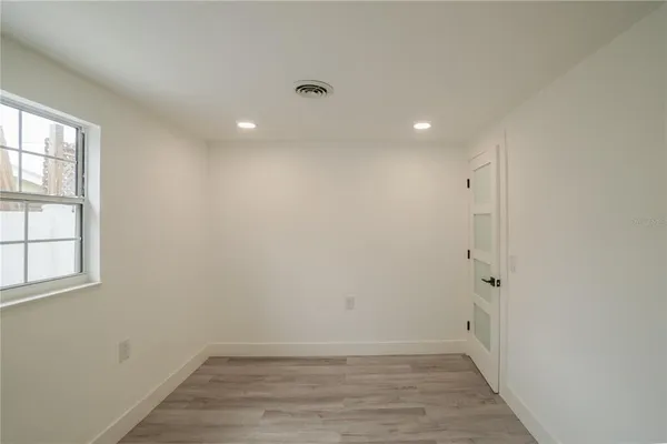 wooden floor in an empty room with a window