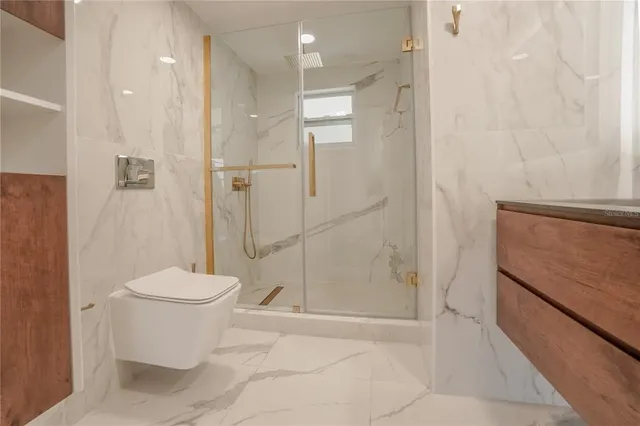a bathroom with a toilet and a shower