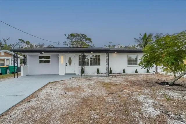 a front view of a house with a garden and garage