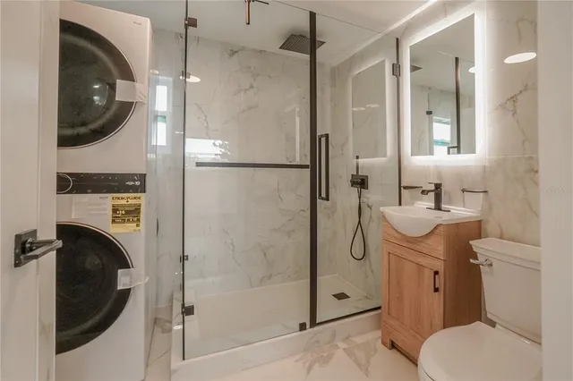 a bathroom with a toilet a sink and shower
