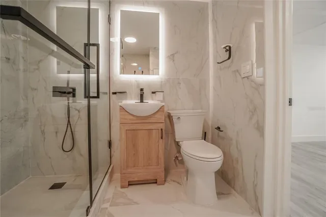 a bathroom with a sink toilet and shower