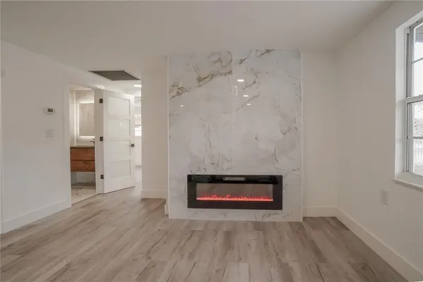 wooden floor in an empty room with a window