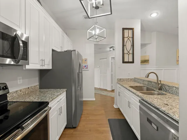 a en suite bathroom with a granite countertop sink and a mirror