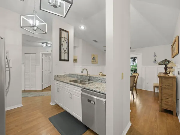 a kitchen with stainless steel appliances kitchen island granite countertop a refrigerator and a stove top oven