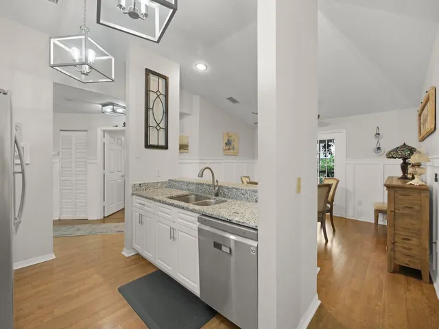 a kitchen with stainless steel appliances kitchen island granite countertop a refrigerator and a stove top oven
