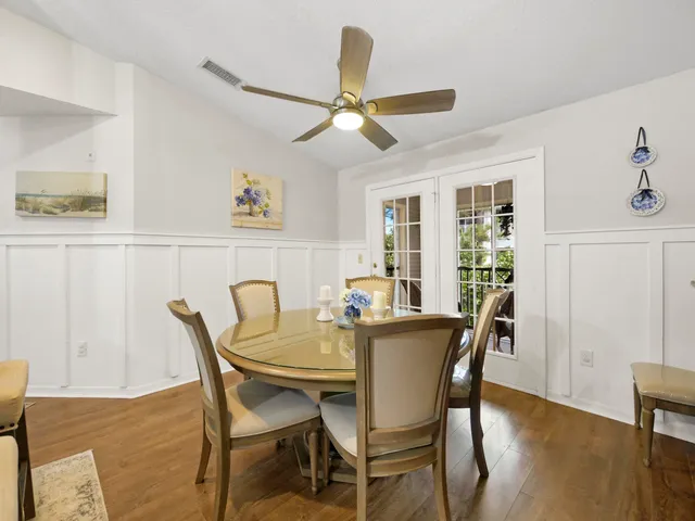 a view of a dining room with furniture and a chandelier
