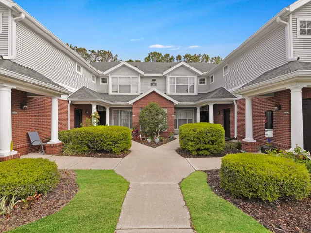 a front view of a house with garden and porch