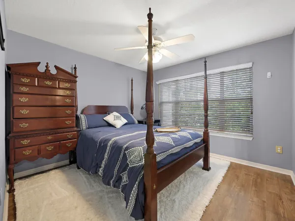 a bed room with a bed and a chandelier