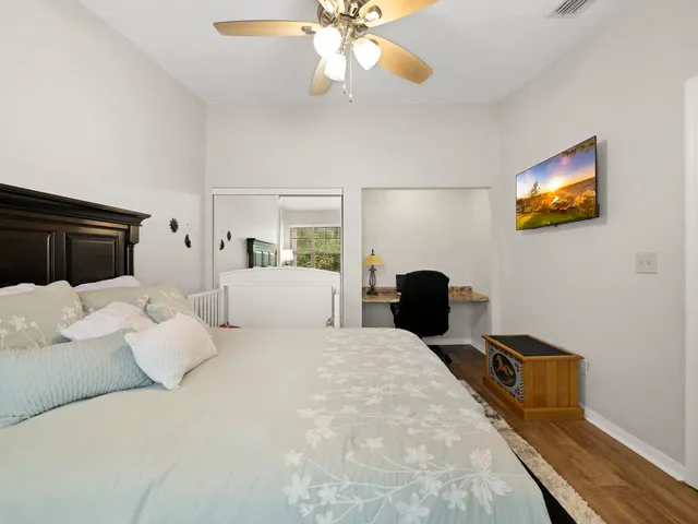 a bedroom with bed and wooden floor