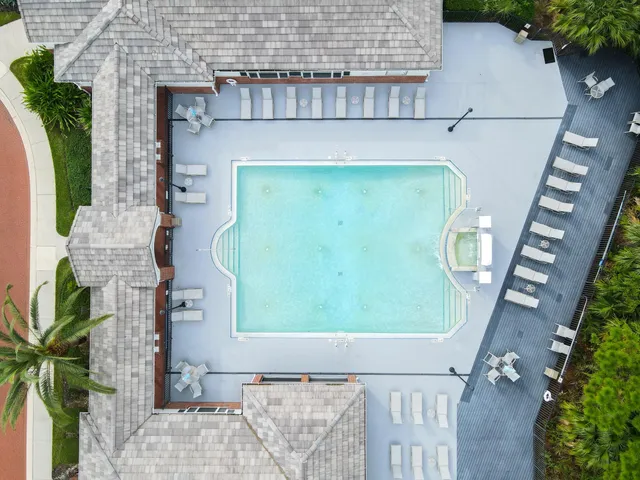 a front view of a house with garden and sitting area